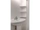 Bathroom featuring pedestal sink, shelving and shower with white tile at 1708 Poplar Ave, Las Vegas, NV 89101
