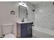 Modern bathroom with marble-look shower and navy blue vanity at 1708 Poplar Ave, Las Vegas, NV 89101