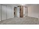 Bedroom with gray wood-look tile flooring, closet and wood accent wall by the door to the bathroom at 1708 Poplar Ave, Las Vegas, NV 89101