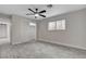 Bedroom featuring gray wood-look tile flooring, ceiling fan, closet and a window with bars at 1708 Poplar Ave, Las Vegas, NV 89101