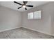 Bedroom featuring gray wood-look tile flooring, ceiling fan, window with bars and white walls at 1708 Poplar Ave, Las Vegas, NV 89101