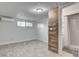 Bedroom featuring gray wood-look tile flooring, closet, air conditioner and access to the bathroom at 1708 Poplar Ave, Las Vegas, NV 89101