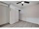 Comfortable bedroom features neutral walls, ceiling fan, closet, and hardwood floors at 1708 Poplar Ave, Las Vegas, NV 89101