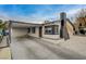 Cozy home with a covered carport, black trim, and a distinctive chimney design for added curb appeal at 1708 Poplar Ave, Las Vegas, NV 89101