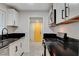 Charming kitchen featuring stainless steel appliances, sleek black countertops and white cabinetry at 1708 Poplar Ave, Las Vegas, NV 89101