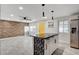 Bright kitchen featuring stainless steel appliances, decorative island and an adjacent living area with wood accent wall at 1708 Poplar Ave, Las Vegas, NV 89101