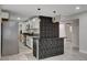 Well-equipped kitchen with stainless steel appliances, sleek countertops, stylish bar and open layout to living area at 1708 Poplar Ave, Las Vegas, NV 89101