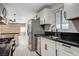 Bright kitchen featuring stainless steel appliances, black countertops and white cabinetry with living area access at 1708 Poplar Ave, Las Vegas, NV 89101