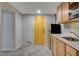 Kitchen area featuring a yellow door, wooden cabinets, marble countertops, and a stainless steel sink at 1708 Poplar Ave, Las Vegas, NV 89101