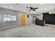 Open-concept living area with stylish flooring, a modern ceiling fan, and a view into the updated kitchen at 1708 Poplar Ave, Las Vegas, NV 89101