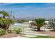 Lush backyard with a pool, well-manicured landscaping, and city views, creating a serene and inviting outdoor living space at 2 Olympia Outlook Dr, Las Vegas, NV 89141