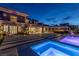 Beautiful backyard with a refreshing pool, spa, covered patio, and outdoor seating areas for ultimate relaxation and entertainment at 2 Olympia Outlook Dr, Las Vegas, NV 89141