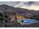 Stunning backyard with a sparkling pool, spa, a covered outdoor dining area, and desert landscaping at 2 Olympia Outlook Dr, Las Vegas, NV 89141