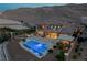 Expansive backyard with a pool, spa, outdoor kitchen, and lounge area, perfect for entertaining at 2 Olympia Outlook Dr, Las Vegas, NV 89141