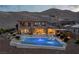 Luxury backyard featuring a sparkling pool, spa, and lush desert landscaping at 2 Olympia Outlook Dr, Las Vegas, NV 89141