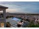 Luxury backyard with a sparkling pool, spa, fire pit, and views of the Las Vegas skyline at 2 Olympia Outlook Dr, Las Vegas, NV 89141