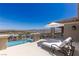 Relaxing balcony view featuring a comfortable chaise lounge, a stylish umbrella, and panoramic city views for ultimate relaxation at 2 Olympia Outlook Dr, Las Vegas, NV 89141