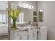Bright bathroom featuring a large vanity with granite countertop, ample lighting, and decorative accents at 2 Olympia Outlook Dr, Las Vegas, NV 89141