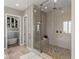 Spacious walk-in shower with stone pebble floor, glass enclosure, and built-in bench seating at 2 Olympia Outlook Dr, Las Vegas, NV 89141