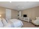 Clean bedroom with carpeted floors, ceiling fan, large windows and decorative furniture at 2 Olympia Outlook Dr, Las Vegas, NV 89141