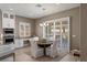 Bright breakfast nook with round table, white chairs, and natural light through shuttered windows at 2 Olympia Outlook Dr, Las Vegas, NV 89141