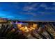 Relaxing firepit area with comfortable seating, a captivating city view, and elegant landscaping for cozy outdoor gatherings at 2 Olympia Outlook Dr, Las Vegas, NV 89141