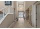Inviting foyer with tile flooring, high ceilings, and a staircase with modern railings, leading to the upper level at 2 Olympia Outlook Dr, Las Vegas, NV 89141