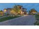 Stunning home featuring an expansive brick driveway, lush landscaping, and a well-maintained lawn at 2 Olympia Outlook Dr, Las Vegas, NV 89141