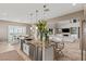 Open concept kitchen with granite counters, stainless appliances, and adjacent living area at 2 Olympia Outlook Dr, Las Vegas, NV 89141