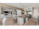 Open floor plan seamlessly connects the living room and kitchen with granite countertops and island at 2 Olympia Outlook Dr, Las Vegas, NV 89141