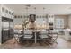 Spacious kitchen features an island, stainless appliances, and breakfast bar seating at 2 Olympia Outlook Dr, Las Vegas, NV 89141