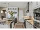 Contemporary kitchen features stainless steel appliances and stone counters at 2 Olympia Outlook Dr, Las Vegas, NV 89141