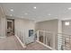 Upstairs landing with modern railings, carpet flooring, and natural lighting at 2 Olympia Outlook Dr, Las Vegas, NV 89141