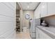 Organized laundry room with shelving, counter space, washer, and dryer at 2 Olympia Outlook Dr, Las Vegas, NV 89141