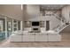 Open-concept living area with a stunning fireplace, a view of the second floor and staircase, and outdoor views at 2 Olympia Outlook Dr, Las Vegas, NV 89141