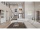 Bright, expansive living room with soaring ceilings and staircase at 2 Olympia Outlook Dr, Las Vegas, NV 89141