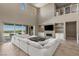 Inviting living room with expansive windows offering panoramic views, complemented by a sleek entertainment center at 2 Olympia Outlook Dr, Las Vegas, NV 89141