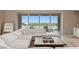 Bright living room featuring a comfortable sectional sofa and scenic views of the pool and distant mountains at 2 Olympia Outlook Dr, Las Vegas, NV 89141