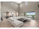 Open-concept living space with large sectional, and view into the kitchen and outdoor living area at 2 Olympia Outlook Dr, Las Vegas, NV 89141
