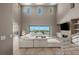 Spacious living room with soaring ceilings, a fireplace, and expansive sliding glass doors opening to a patio and pool at 2 Olympia Outlook Dr, Las Vegas, NV 89141