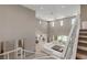 Open-concept living room with modern decor, high ceilings, and access to outdoor patio at 2 Olympia Outlook Dr, Las Vegas, NV 89141