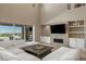 Bright living room features a stone accent wall, fireplace, and seamless access to the outdoors at 2 Olympia Outlook Dr, Las Vegas, NV 89141