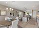 Open-concept living space with large kitchen island, dining area and staircase at 2 Olympia Outlook Dr, Las Vegas, NV 89141