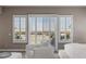 Main bedroom sitting area with views, shutters, and bright, neutral decor at 2 Olympia Outlook Dr, Las Vegas, NV 89141