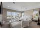 Bright main bedroom with sitting area, plush white seating, and neutral decor at 2 Olympia Outlook Dr, Las Vegas, NV 89141