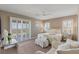 Bright main bedroom boasts a ceiling fan, plush seating, and large windows at 2 Olympia Outlook Dr, Las Vegas, NV 89141
