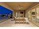 Outdoor living area featuring a stone fireplace, comfortable seating, and city views at 2 Olympia Outlook Dr, Las Vegas, NV 89141