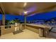 Outdoor kitchen featuring a grill, bar seating, and stunning views of the Las Vegas skyline at 2 Olympia Outlook Dr, Las Vegas, NV 89141