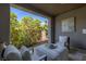 Comfortable covered patio featuring plush seating and views of the landscaped backyard, perfect for outdoor relaxation at 2 Olympia Outlook Dr, Las Vegas, NV 89141
