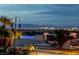 Inviting pool area with comfortable lounge chairs and panoramic city views at dusk at 2 Olympia Outlook Dr, Las Vegas, NV 89141